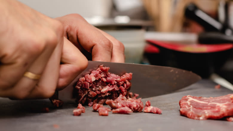 chopping steak tartare with knife