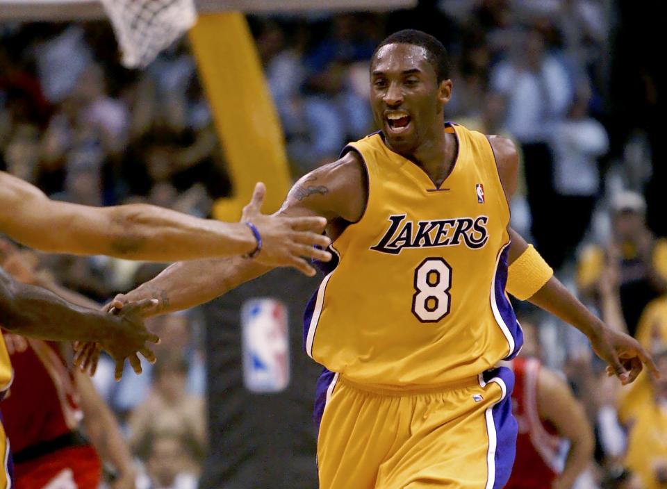 Los Angeles lakers' Kobe Bryant is congratulated after scoring a basket during the second quarter against the Houston Rockets during their NBA Western Conference first-round game Monday, April 28, 2004, at Staples Center in Los Angeles.  (AP Photo/Kevork Djansezian)