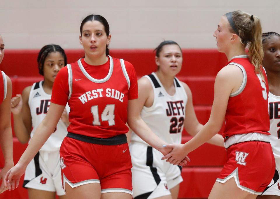 West Lafayette Red Devils forward Annie Karlaftis (14) high fives West Lafayette Red Devils guard Sarah Werth (5) during the IHSAA girl’s basketball game against the Lafayette Jeff Bronchos, Tuesday, Jan. 17, 2023, at Lafayette Jeff High School in Lafayette, Ind. 
