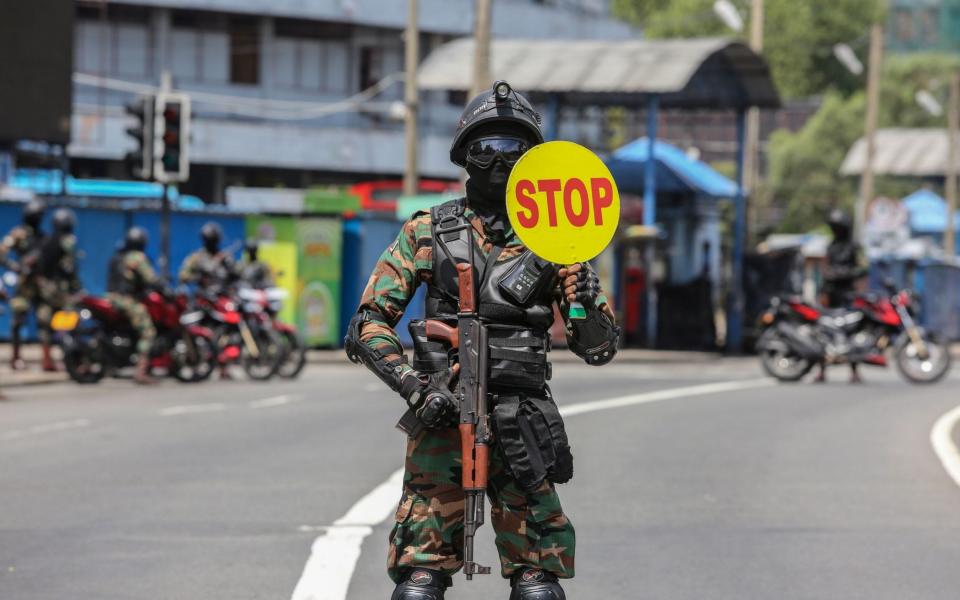  Sri Lankan Army soldiers stop vehicles at a checkpoint after the government announced an island-wide travel restrictions as a preventive measure against the spread of Covid-19 - CHAMILA KARUNARATHNE/EPA-EFE/Shutterstock 