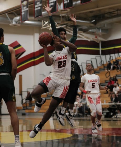 RANCHO CUCAMONGA, CA - MAY 7, 2021: Etiwanda Marcus Green (23) drives to the basket against Damien Chris Nickelberry (3) in the first half at Etiwanda High School on May 7, 2021 in Rancho Cucamonga, California.(Gina Ferazzi / Los Angeles Times)