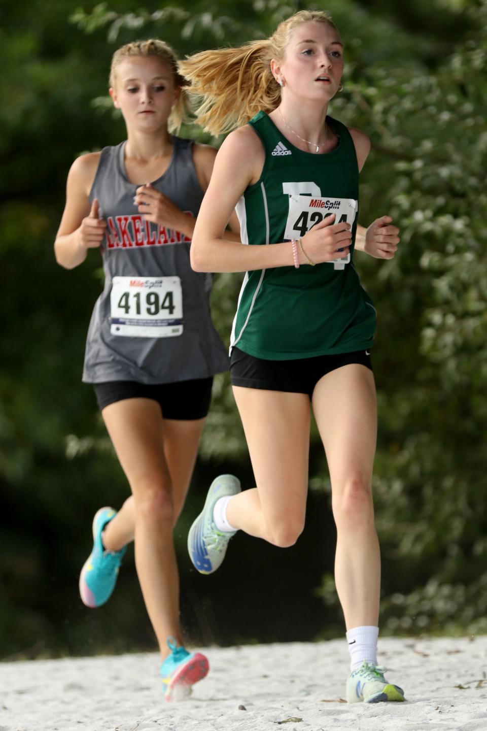 Katharine Cottone (green shirt), of Passaic Valley is shown as she heads to a fifth place finish, with a time of 20:30. Just behind Cottone is Kayla Bamhardt, of Lakeland, who came in seventh place with a time of 21:02. Tuesday September 21,  2021