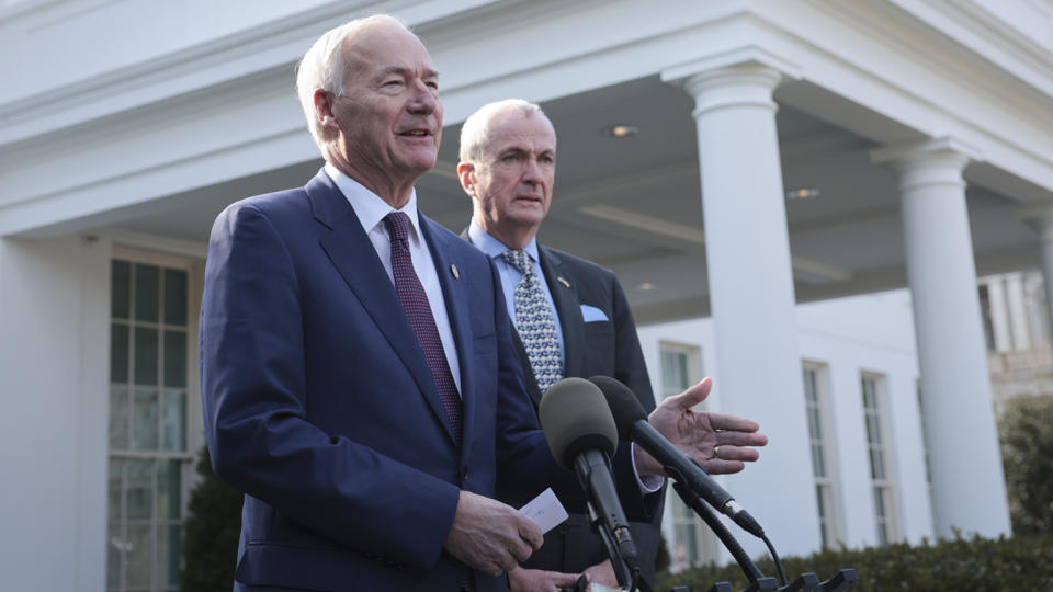 Arkansas Gov. Asa Hutchinson, chairman of the National Governors Association, joined by New Jersey Gov. Phil Murphy, speaks outside the White House.