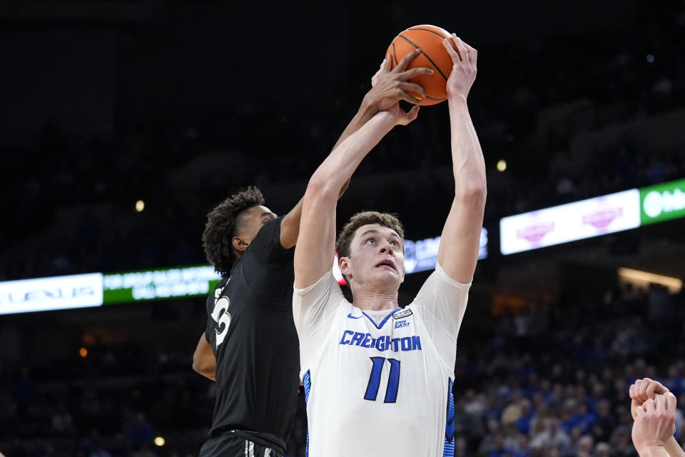 Xavier guard Dailyn Swain (3) blocks a shot by Creighton center Ryan Kalkbrenner (11) during the first half of an NCAA college basketball game, Tuesday, Jan. 23, 2024, in Omaha, Neb. (AP Photo/Charlie Neibergall)