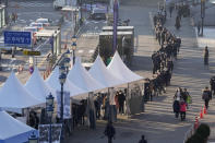 People queue in line to wait for the coronavirus testing at a makeshift testing site in Seoul, South Korea, Wednesday, Dec. 8, 2021. (AP Photo/Ahn Young-joon).