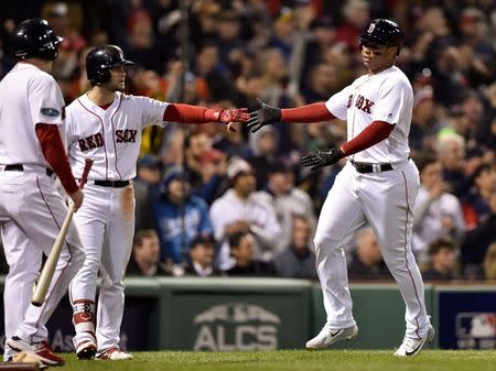 Oct 14, 2018; Boston, MA, USA; Boston Red Sox third baseman Rafael Devers (11) celebrates his run in the eighth inning with left fielder Andrew Benintendi (16) in game two of the 2018 ALCS playoff baseball series against the Houston Astros at Fenway Park. Mandatory Credit: Bob DeChiara-USA TODAY Sports