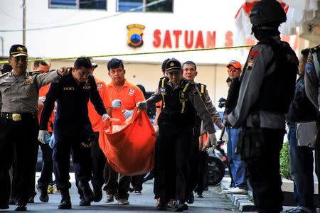 Police remove the body of a suicide bomber from the scene of an attack in Solo, Central Java, Indonesia on July 5, 2016 in this photo taken by Antara Foto. Antara Foto/Maulana Surya/via REUTERS/Files