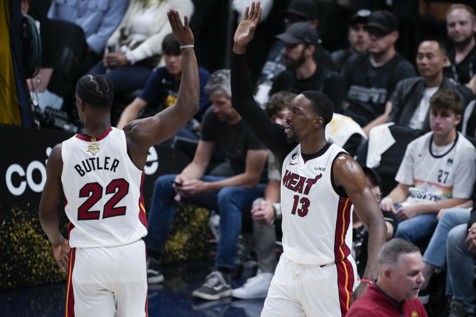 Miami Heat center Bam Adebayo, right, celebrates with forward Jimmy Butler after scoring against the Denver Nuggets during the second half of Game 2 of basketball's NBA Finals, Sunday, June 4, 2023, in Denver. (AP Photo/David Zalubowski)