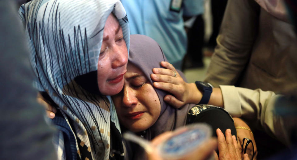 Indonesian relatives of the plane crash victims cry as they wait for the news at the airport in Pangkal Pinang, Indonesia. Source: AAP