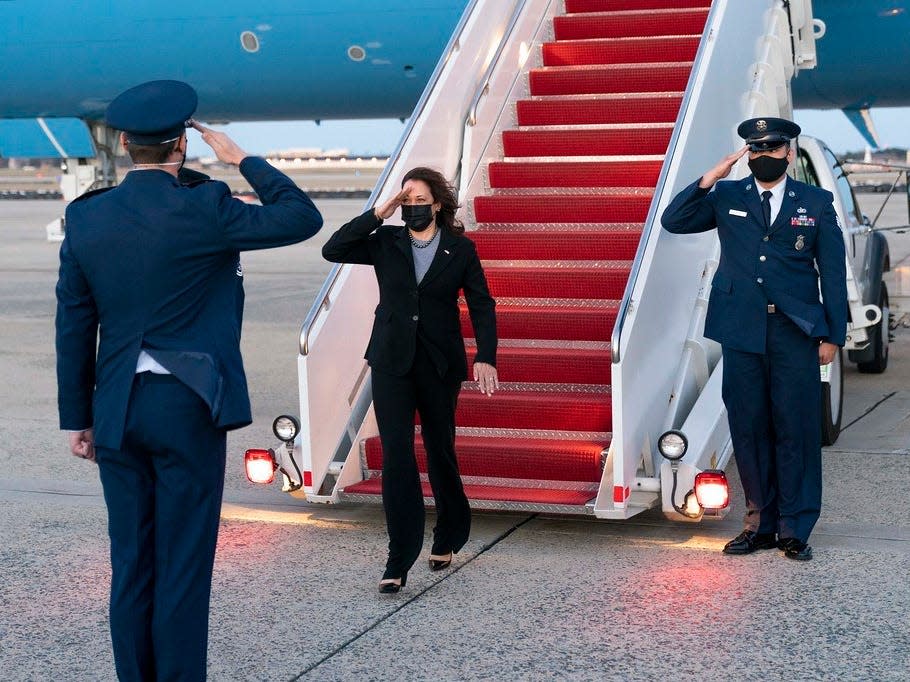 Vice President Kamala Harris salutes as she disembarks Air Force Two