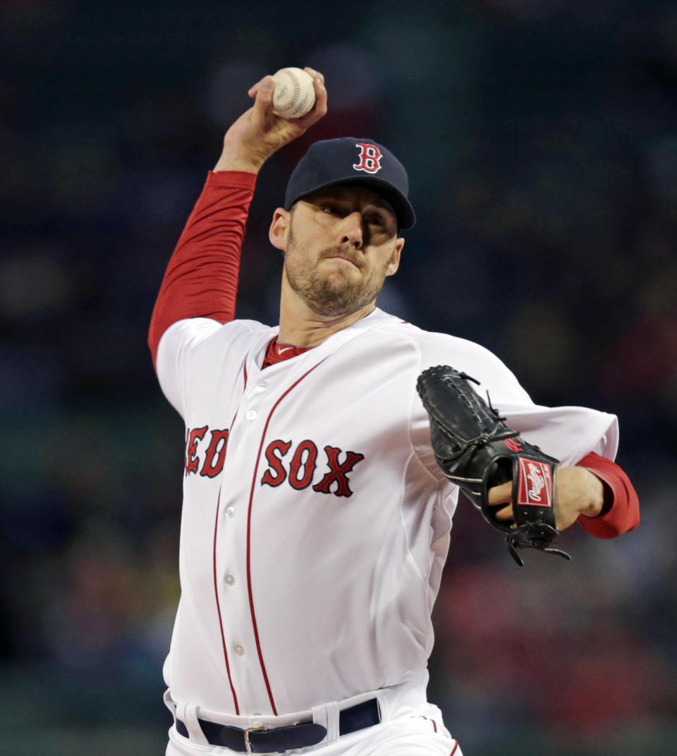 Boston Red Sox starting pitcher John Lackey delivers against the Texas Rangers during the first inning of a baseball game at Fenway Park, Monday, April 7, 2014, in Boston. (AP Photo/Charles Krupa)