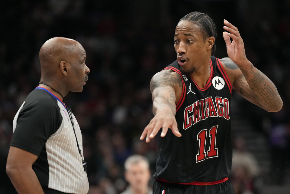 Referee Derek Richardson, left, listens as Chicago Bulls forward DeMar DeRozan (11) tries to dispute a technical foul call during second-half NBA basketball game action against the Toronto Raptors in Toronto, Sunday, Nov. 6, 2022. (Frank Gunn/The Canadian Press via AP)