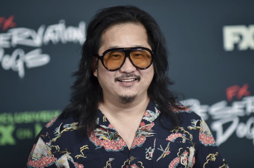 Bobby Lee smiles while wearing large sunglasses and a printed shirt