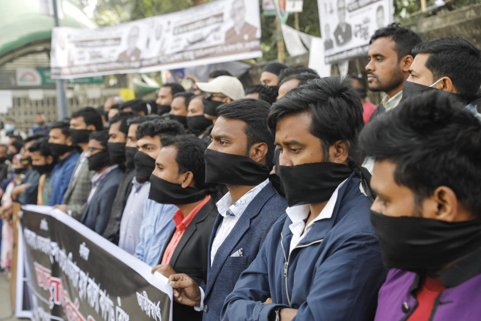 Activists of Gono Odhikar Parishad stand wearing black clothes on the face to protest against what they called a one sided election at the National Press Club in Dhaka, Bangladesh, Monday, Jan.8, 2024. Prime Minister Sheikh Hasina has won an overwhelming majority in Bangladesh's parliamentary election after a campaign fraught with violence and a boycott from the main opposition party, giving her and her Awami League a fourth consecutive term. (AP Photo/Mahmud Hossain Opu)