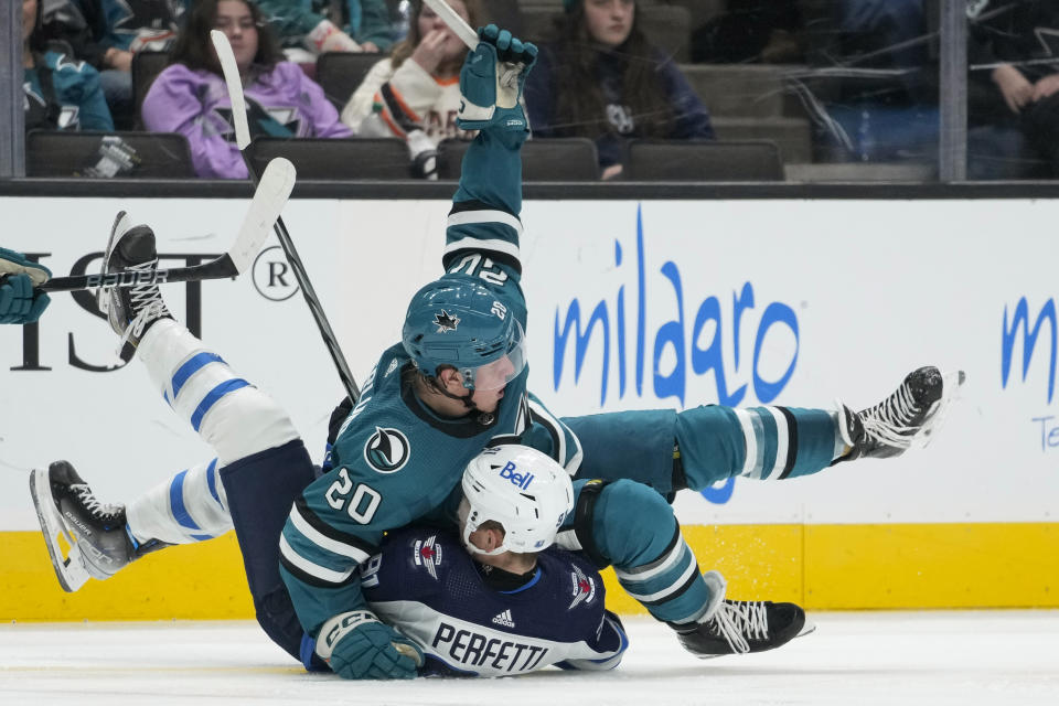 San Jose Sharks left wing Fabian Zetterlund (20) and Winnipeg Jets center Cole Perfetti collide during the second period of an NHL hockey game Tuesday, Dec. 12, 2023, in San Jose, Calif. (AP Photo/Godofredo A. Vásquez)