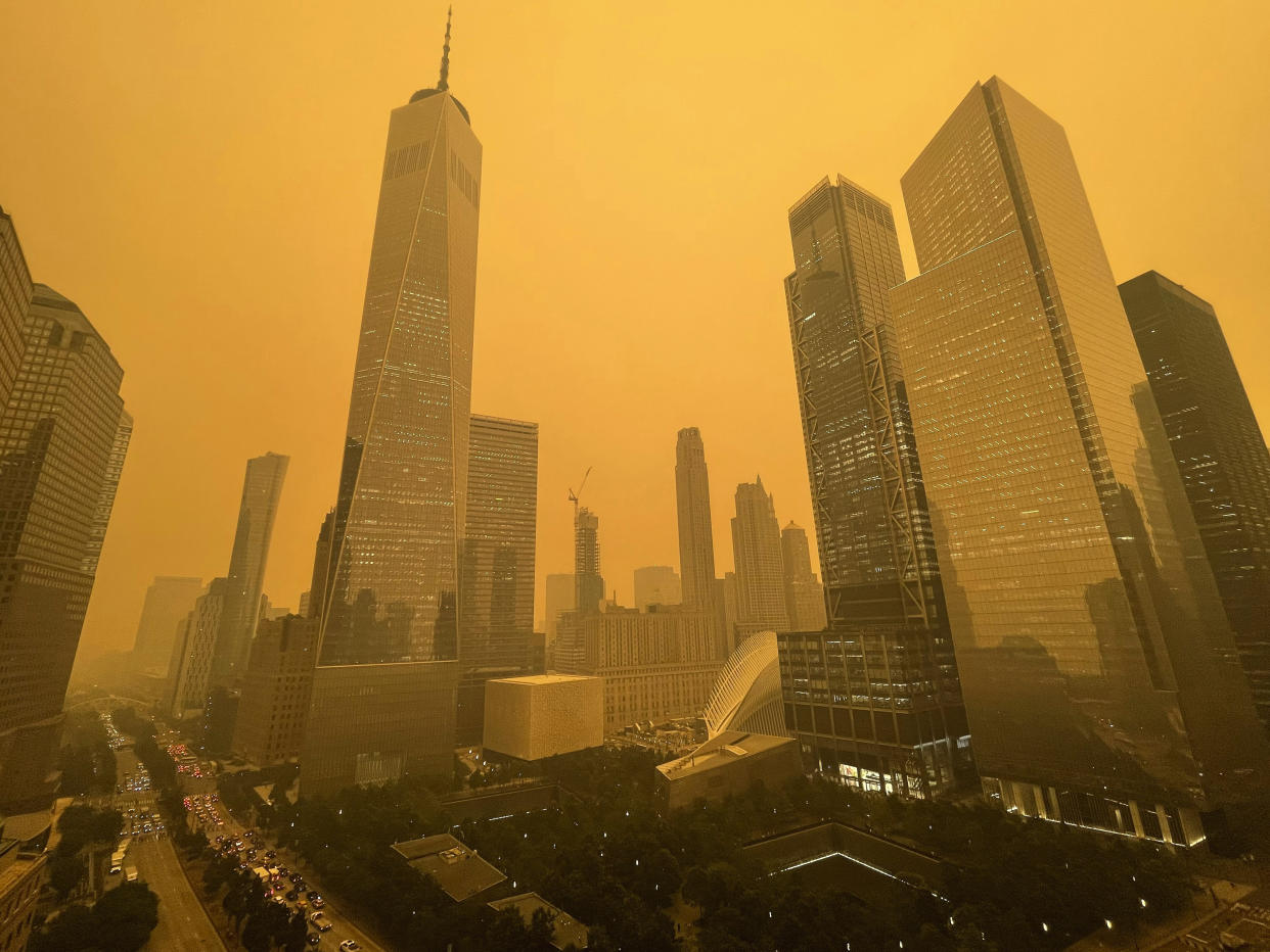 Highrises in Manhattan, shrouded in an orange haze.