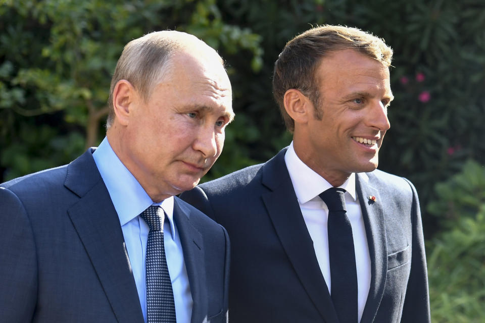 French President Emmanuel Macron, right, welcomes Russian President Vladimir Putin at the Fort of Bregancon in Bormes-les-Mimosas, southern France, Monday Aug. 19, 2019. French President Emmanuel Macron and Russian President Vladimir Putin are meeting to discuss the world's major crises, including Ukraine, Iran and Syria, and try to improve Moscow's relations with the European Union. (Gerard Julien, Pool via AP)