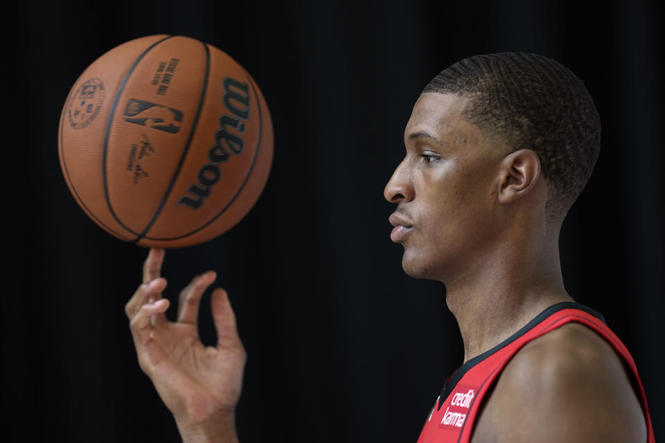 Houston Rockets' Jabari Smith Jr. spins a basketball while posing for a photographer during an NBA basketball media day Monday, Sept. 26, 2022, in Houston. (AP Photo/David J. Phillip)