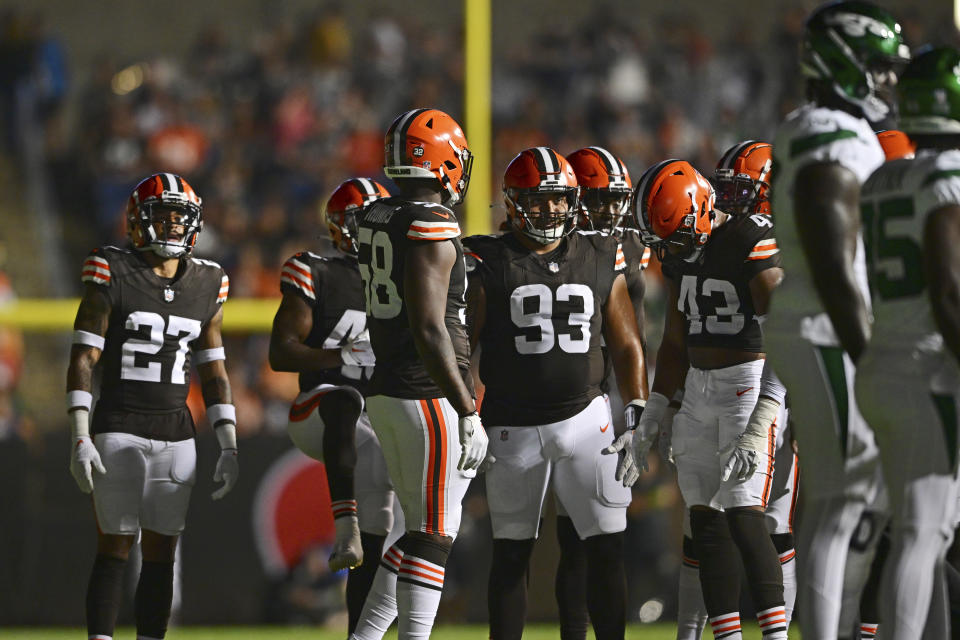 Cleveland Browns and New York Jets mill about after many of the stadium lights went out during the second half of the Hall of Fame NFL football preseason game Thursday, Aug. 3, 2023, in Canton, Ohio. (AP Photo/David Dermer)
