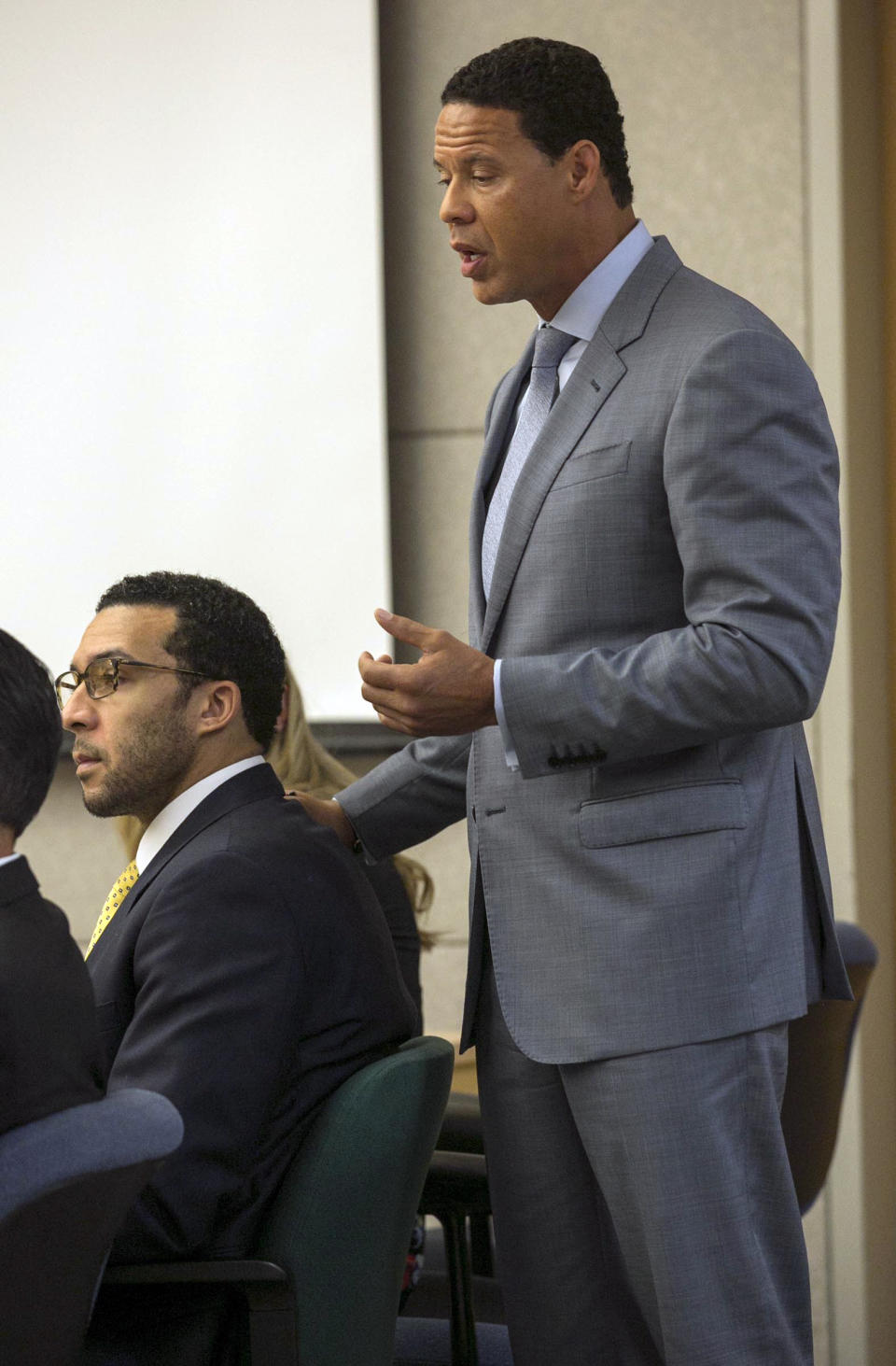 Brian Watkins, right, an attorney for former NFL football player Kellen Winslow Jr., puts his hands on Winslow as he gives his opening statement to the jury during Winslow's rape trial, Monday May 20, 2019, in Vista, Calif. (John Gibbins/The San Diego Union-Tribune via AP, Pool)