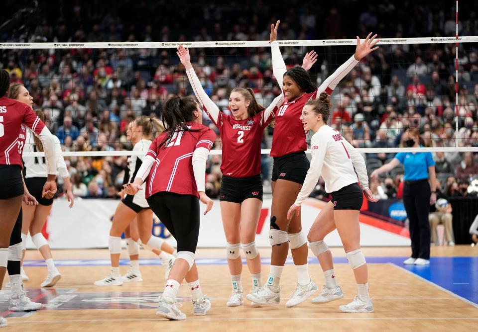 Wisconsin Badgers celebrate a point during the NCAA volleyball championship final four against the Louisville Cardinals at Nationwide Arena in Columbus on Thursday, Dec. 16, 2021. 