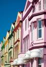 <p>Pastel homes with complementary trim are coordinated on the streets of England.</p>