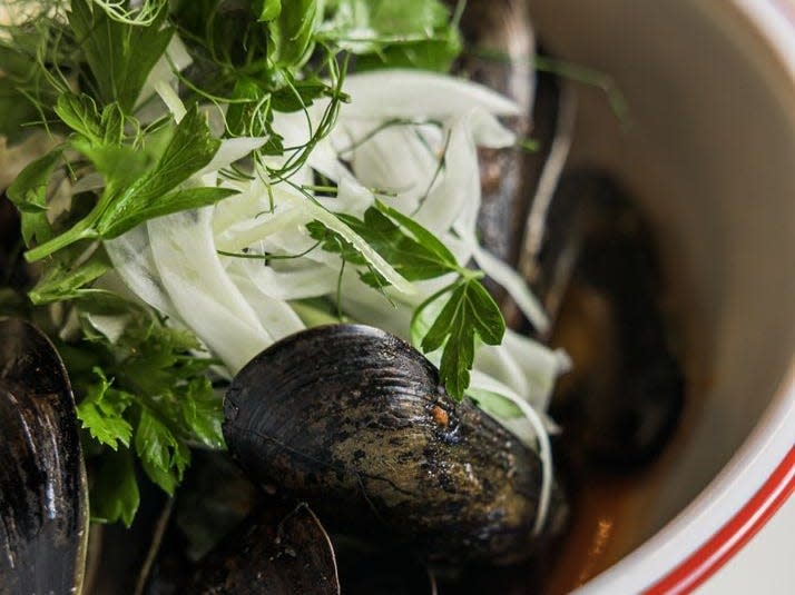 Bowl of clams with garnish.