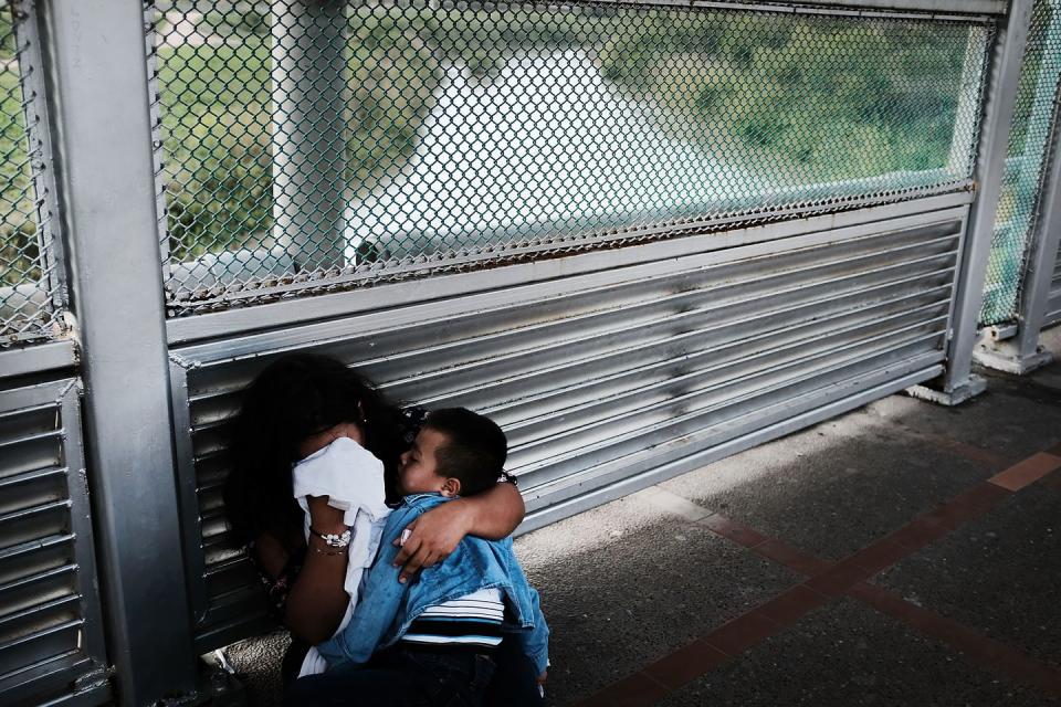 <p>A Honduran woman cries while holding her child after being denied entry at the border in Brownsville, Texas. </p>