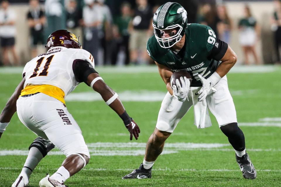 Michigan State tight end Evan Morris (92) makes catch against Central Michigan linebacker Dakota Cochran (11) during the second half at Spartan Stadium in East Lansing on Friday, Sept. 1, 2023.