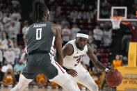 Arizona State guard Marreon Jackson drives on Washington State forward Efe Abogidi (0) during the second half of an NCAA college basketball game, Wednesday, Dec. 1, 2021, in Tempe, Ariz. Washington State won 51-29. (AP Photo/Rick Scuteri)