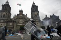 Riot policemen charge past the cathedral during protests in Mexico City September 13, 2013. (REUTERS/Tomas Bravo)