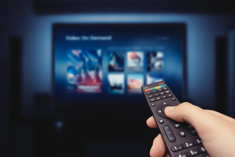 Person holding a remote for their Smart TV