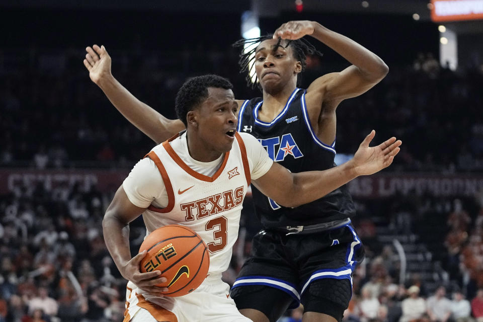 Texas guard Max Abmas (3) drives around Texas-Arlington guard Kade Douglas (13) during the second half of an NCAA college basketball game in Austin, Texas, Monday, Jan. 1, 2024. (AP Photo/Eric Gay)