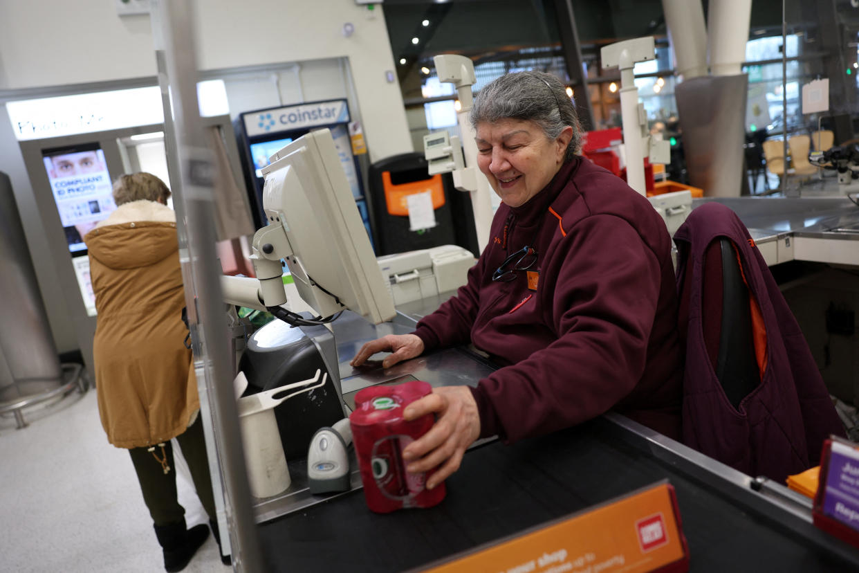 A cashier scans products at the till inside a Sainsbury's supermarket in Richmond, West London, in London, Britain February 21, 2024. REUTERS/Isabel Infantes