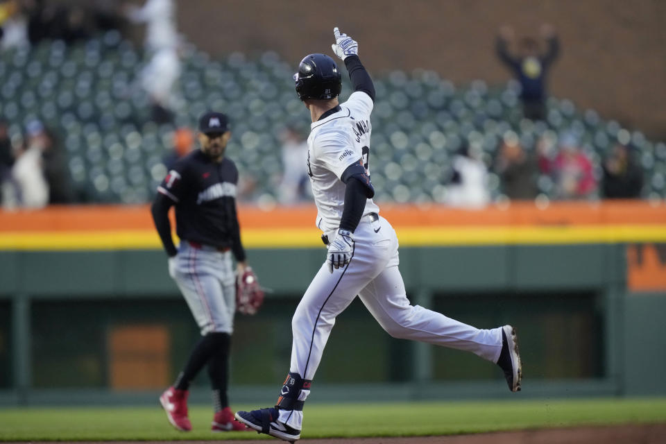 Detroit Tigers' Mark Canha points as he rounds the bases after a solo hoome run off Minnesota Twins pitcher Pablo López during the first inning of a baseball game, Friday, April 12, 2024, in Detroit. (AP Photo/Carlos Osorio)
