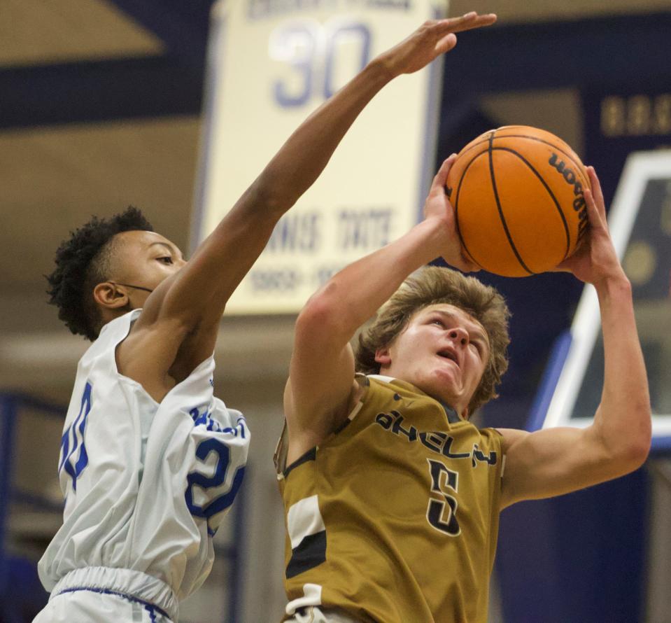 Shelby's Drew Hollifield (right) goes strong toward the basket during his team's hoops matchup with Cherryville on Dec. 17, 2021.