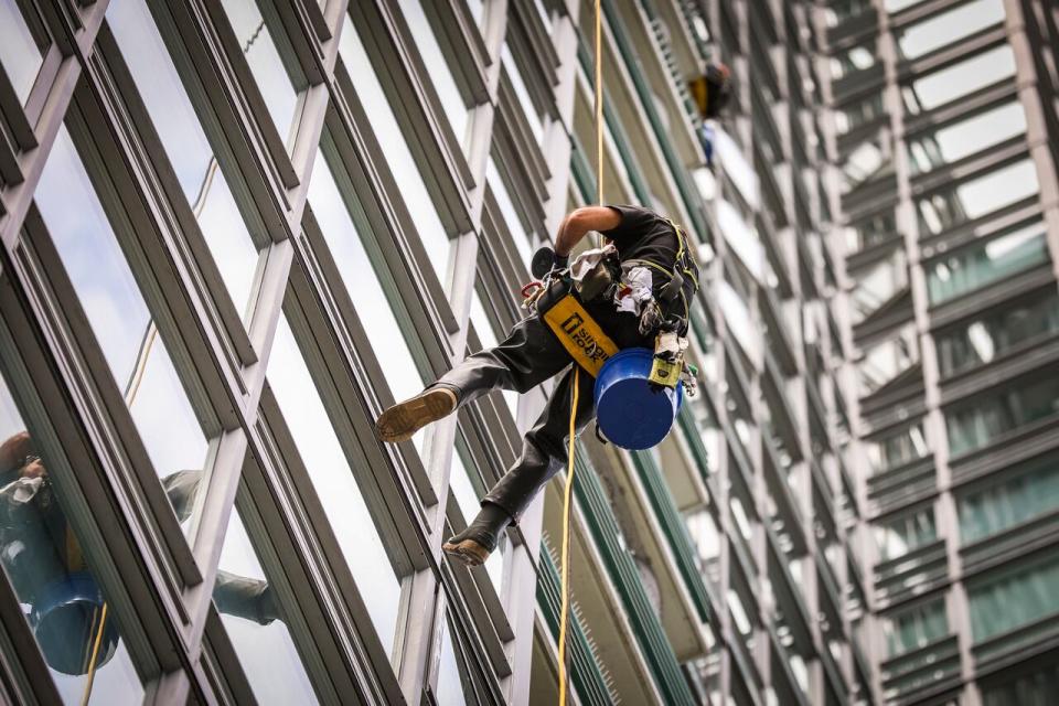 A window washer is pictured in Vancouver on May 13. Canada's economy added 27,000 jobs in May, while unemployment inched up slightly to 6.2 per cent, according to Statistics Canada. (Hunter Soo/CBC - image credit)