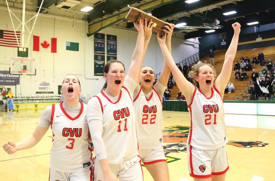 The Redhawk captains bring the trophy to their teammates after CVU's 38-33 win over St. Johnsbury the D1 State Championship game on Wednesday night at UVM's Patrick Gym.
