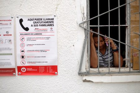 A Central American migrant uses a phone at a migrant shelter in Ciudad Juarez