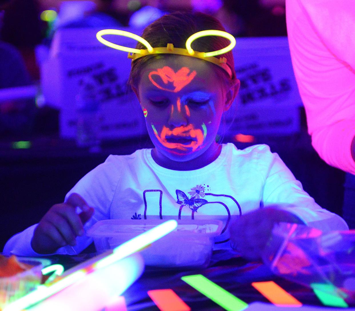 Scarlett Anderson, 5, uses supplies from her STEM SAK Bundle to perfom a science experiment on Friday March 1, 2024, during the 2nd annual Family Glow Night at B.L. Miller Elementary School.