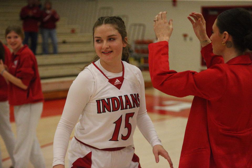 Twin Lakes senior Olivia Nickerson (center) smiles during pregame introductions before playing Faith Christian at the Twin Lakes Holiday Tournament on Wednesday, Dec. 27, 2023.