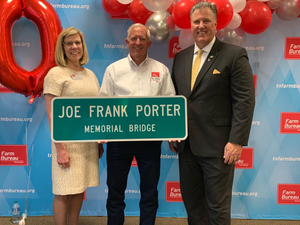 From left, TN Farm Bureau Executive Vice President Rhedona Rose, President Jeff Aiken and State Rep. Scott Cepicky hold new signage for the Joe Frank Porter Bridge, which will replace the existing signs off Williamsport Pike first erected in 1951 in tribute to the organization's founder and first president.