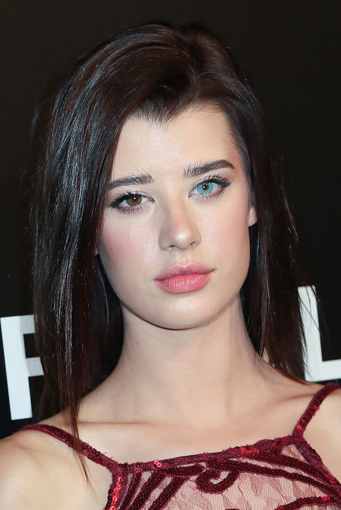 Close-up of Sarah with sleek hair, makeup, and a lace dress