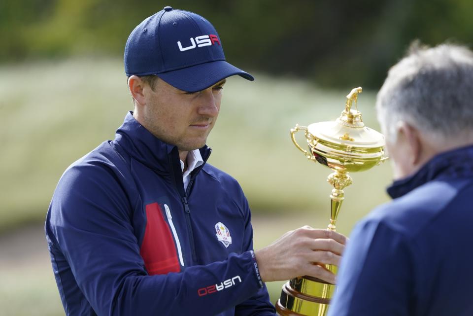 Team USA's Jordan Spieth looks at the Ryder Cup before a team photo during a practice day at the Ryder Cup at the Whistling Straits Golf Course Wednesday, Sept. 22, 2021, in Sheboygan, Wis. (AP Photo/Charlie Neibergall)