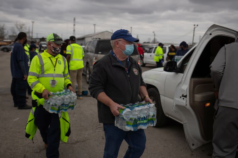 Volunteers give water to residents affectred by unprecedented winter storm in Houston, Texas