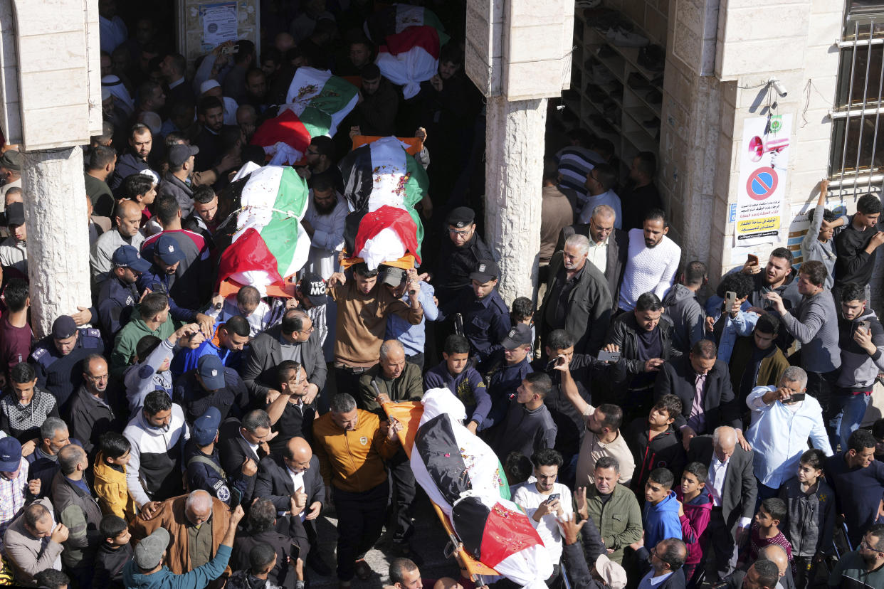 Mourners carry five of the bodies from 21 members of the Abu Raya family where killed in a fire, during their funeral in front of the mosque in Jebaliya refugee camp, northern Gaza Strip, Friday, Nov. 18, 2022. A fire set off by stored gasoline in a residential building killed 21 people Thursday evening in a refugee camp in the northern Gaza Strip, the territory's Hamas rulers said, in one of the deadliest incidents in recent years outside the violence stemming from the Israeli-Palestinian conflict. (AP Photo/Adel Hana)