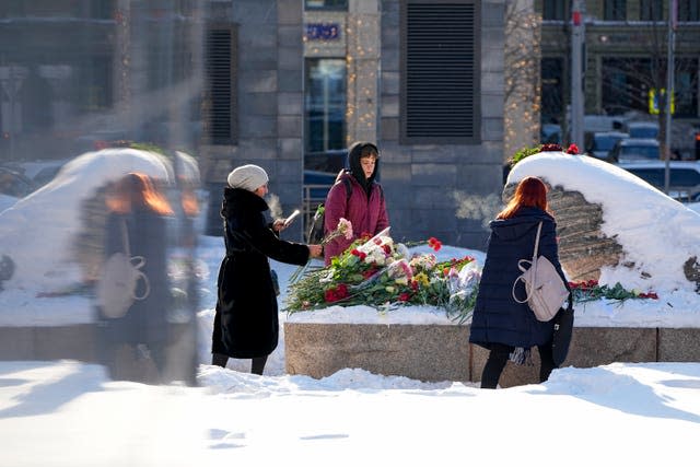 People lay flowers to pay the last respects to Alexei Navalny in Moscow, Russia