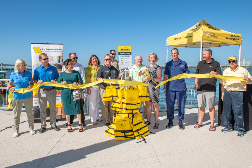 The National Safe Boating Council, US Coast Guard, City of Clearwater officials, County Commissioners, Sea Tow franchises and Sea Tow Services International joined Sea Tow Foundation to celebrate the opening of the 1,000th Life Jacket Loaner Stand.