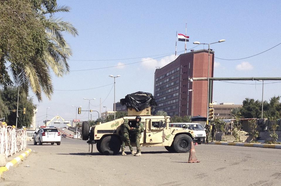 Iraqi security forces secure a road after bomb attacks outside the Green Zone in Baghdad