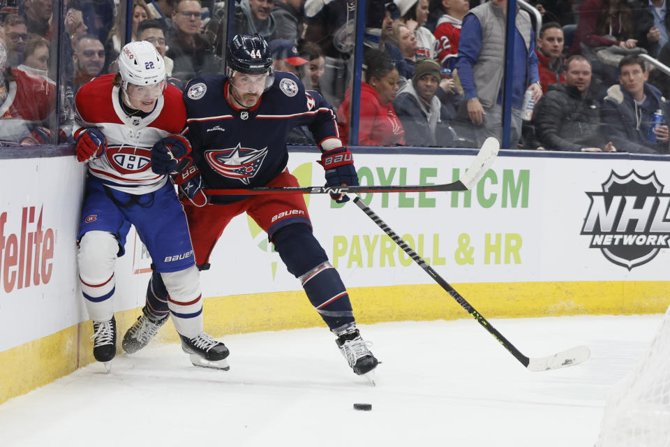 Montreal Canadiens' Cole Caufield, left, and Columbus Blue Jackets' Erik Gudbranson chase the puck during the first period of an NHL hockey game Thursday, Nov. 17, 2022, in Columbus, Ohio. (AP Photo/Jay LaPrete)